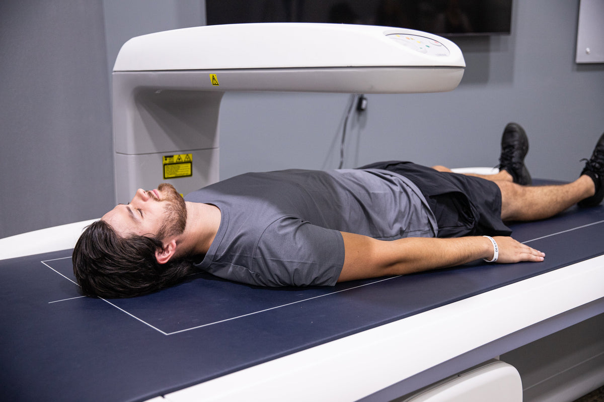 Person lying on a DEXA scanner to measure visceral fat and body composition