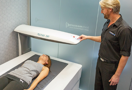 A woman have a dexa scan for bone health and body composition