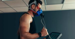 Person on a treadmill wearing a metabolic cart for exercise testing