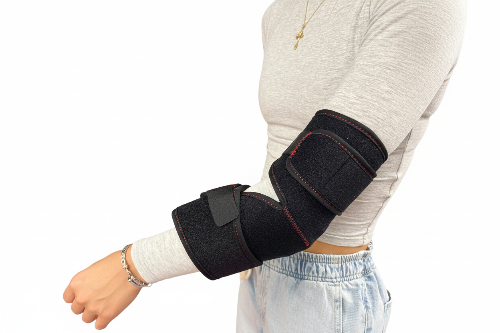 Person wearing a black elbow brace on a white background