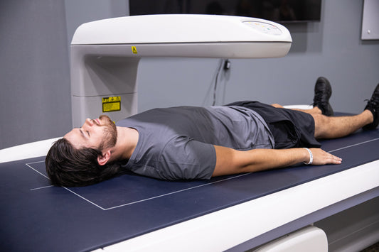 Person lying on a DEXA scanner to measure visceral fat and body composition