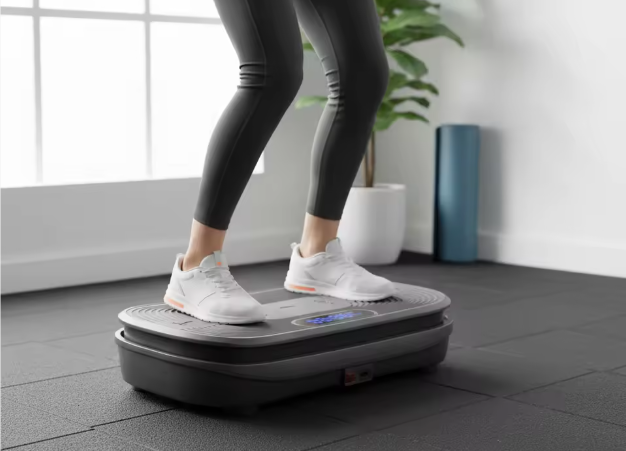 Person using a vibration plate machine in a home setting