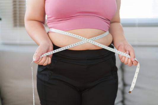 Woman measuring her weight loss